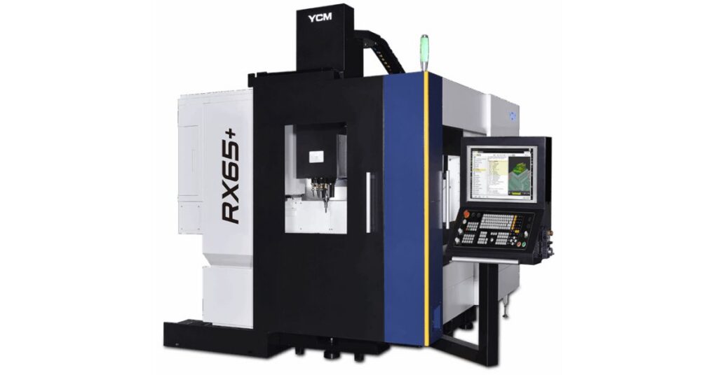 A white-and-black YCM Alliance 5-axis vertical machining center. The model number is displayed on the side as "RX65+".