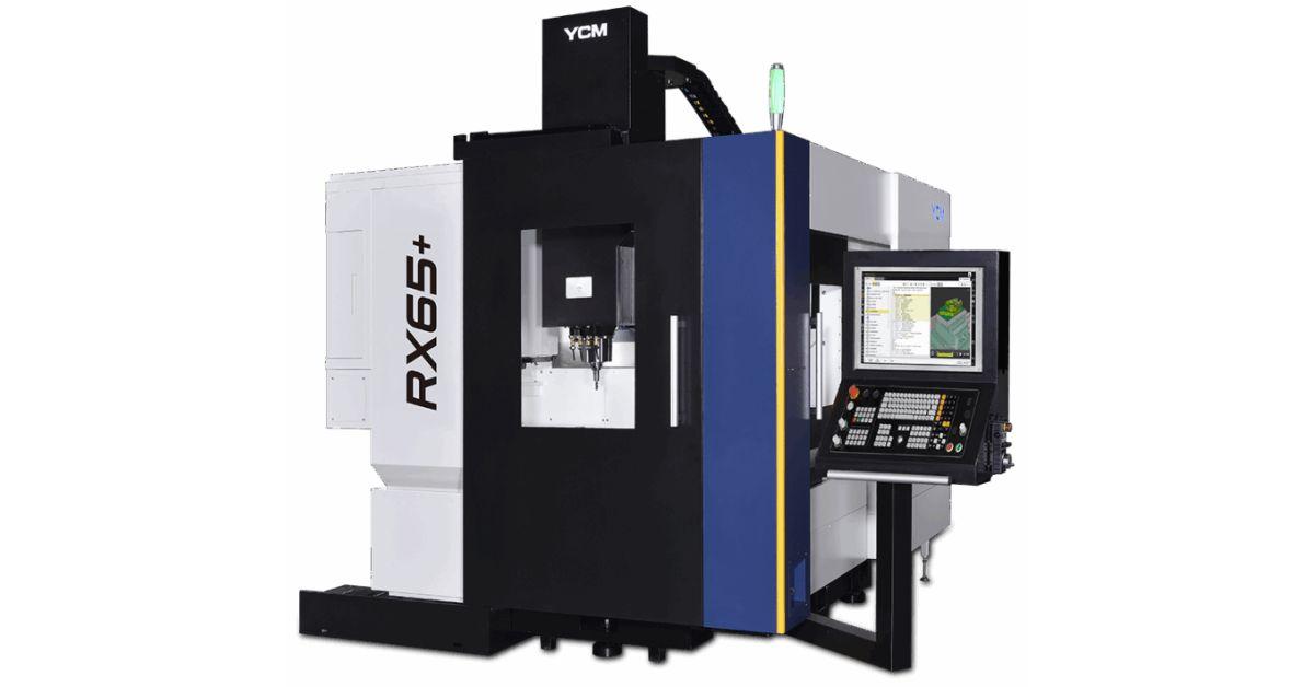A white-and-black YCM Alliance 5-axis vertical machining center. The model number is displayed on the side as "RX65+".