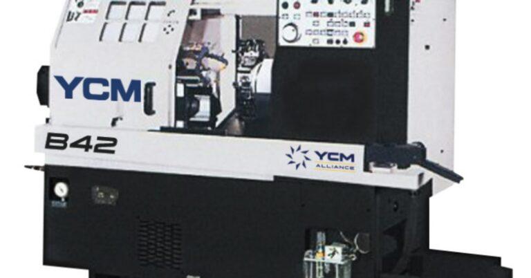 A large CNC machine is white on top and black on the bottom. It has a touchscreen at the top and buttons.