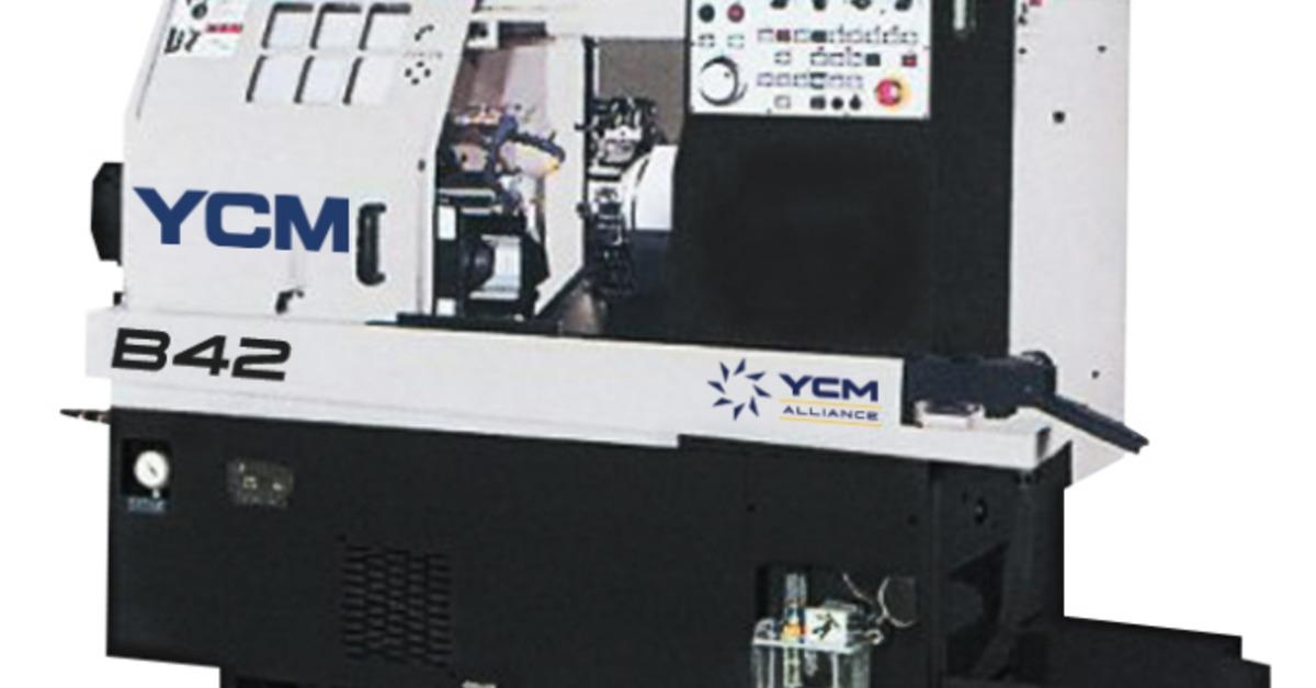 A large CNC machine is white on top and black on the bottom. It has a touchscreen at the top and buttons.
