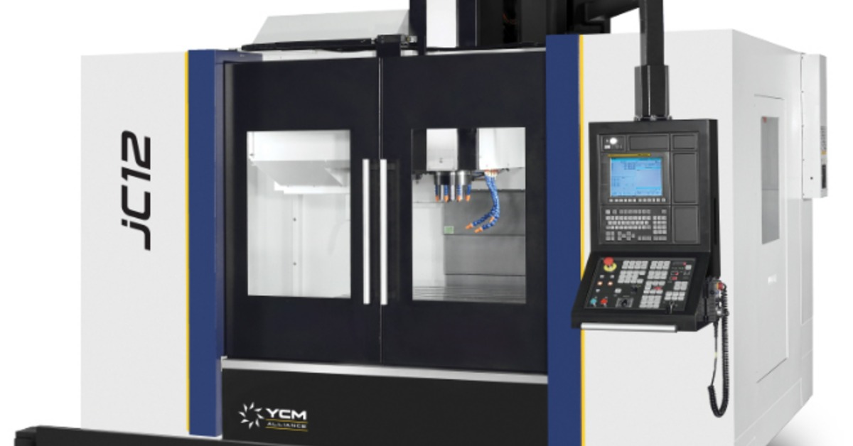 A large, black, blue, and white CNC machine features double doors. A laptop with a screen and keyboard is on the side.