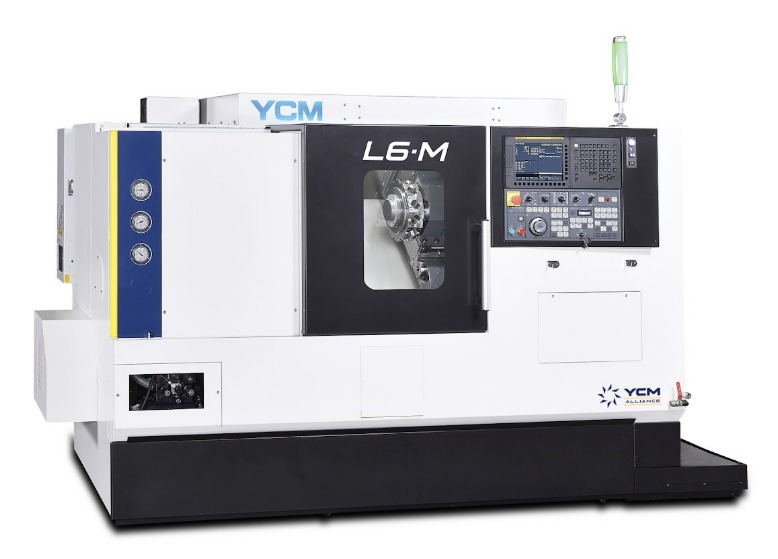 A large white CNC machine features a small window to view inside the machine and a keyboard that sits to the side.