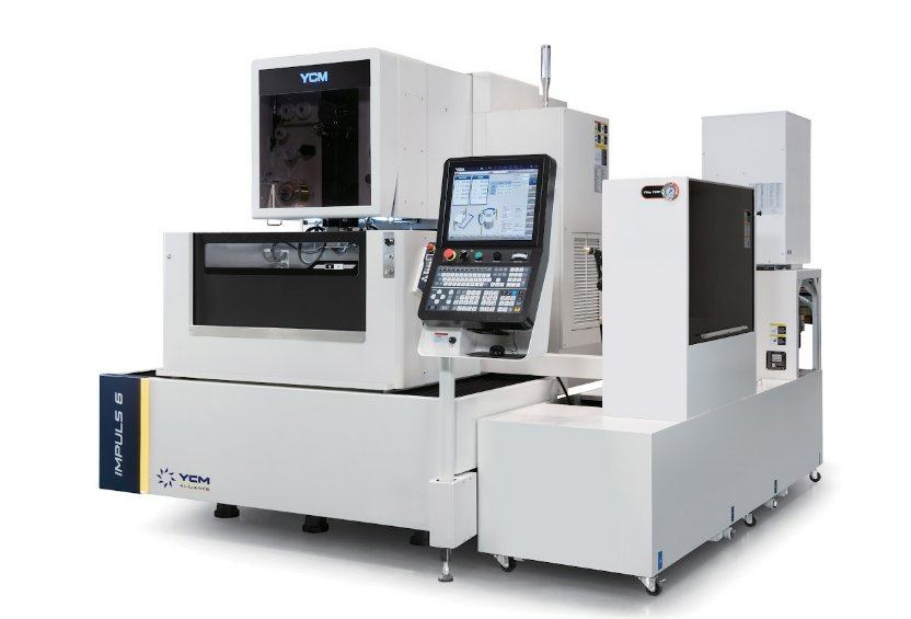 An industrial CNC machine has two tinted viewing areas and a large computer with a keyboard to operate the machine.
