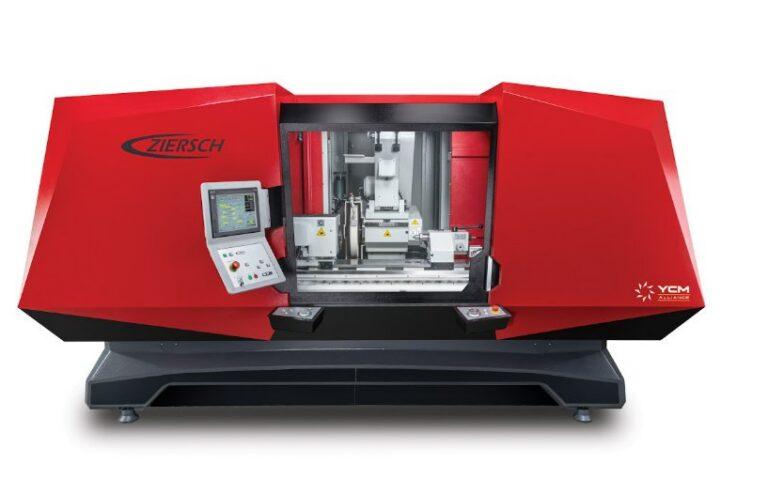 A large red and black industrial machine has a window in the middle showing the intricate details inside.