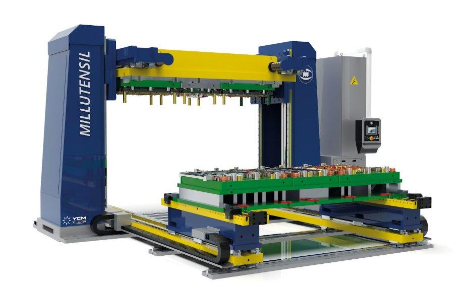 A large blue and yellow industrial machine features a square filled with molding presses that sits on a moveable belt.