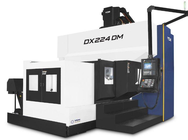 An oversized CNC machine has black stairs leading to a window on the machine. It has a panel with many buttons.
