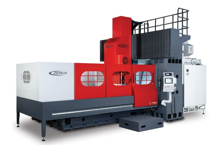 An oversized red, white, and gray industrial machine sits on a plain white background. A laptop is attached to the side.