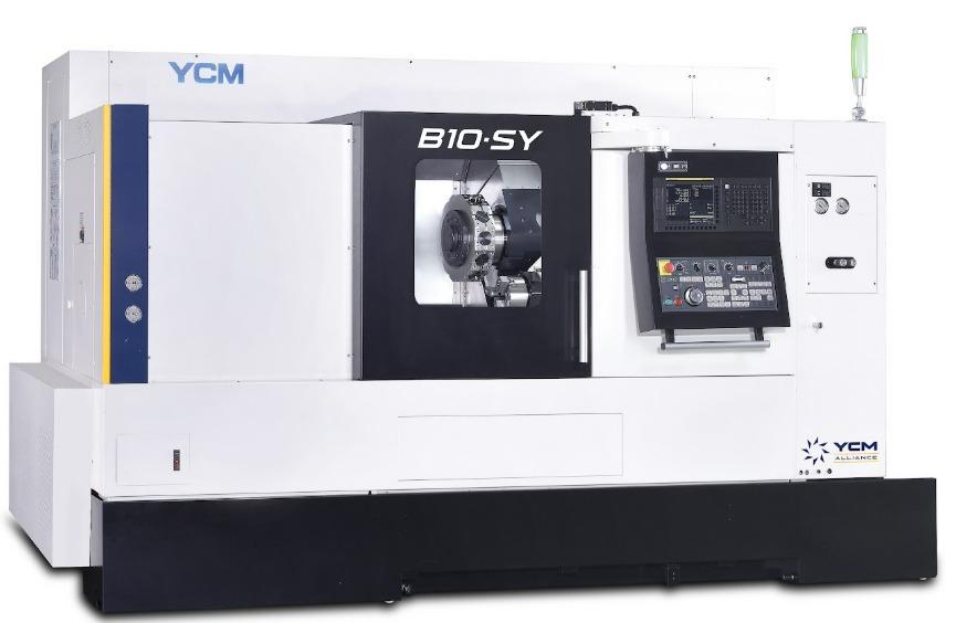 An oversized CNC machine features a console with a lot of buttons and controls. A square window is in the center.