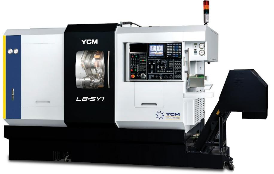 A large gray and black CNC machine has a center window and a built-in console on the right-hand side with several buttons.